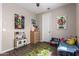 Charming bedroom featuring a playful decor with a cozy single bed and vibrant wall art at 8430 W Atlantis Way, Tolleson, AZ 85353