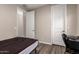This bedroom is a well-lit space with wood-look flooring and two doors for easy access at 8430 W Atlantis Way, Tolleson, AZ 85353