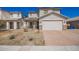 Charming two-story home featuring a two-car garage, desert landscaping, and welcoming front porch at 8430 W Atlantis Way, Tolleson, AZ 85353