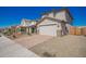 Well-maintained home with a two-car garage, paved driveway, and desert landscaping creating a welcoming atmosphere at 8430 W Atlantis Way, Tolleson, AZ 85353