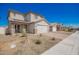 Beautiful home showcasing a two-car garage, desert landscaping, and a paved driveway on a sunny day at 8430 W Atlantis Way, Tolleson, AZ 85353