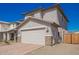Inviting home featuring a two-car garage, desert landscaping, and a well-manicured front yard at 8430 W Atlantis Way, Tolleson, AZ 85353
