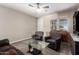 Cozy living room with two chairs, wood-look flooring, and a door leading to a room with plenty of light at 8430 W Atlantis Way, Tolleson, AZ 85353