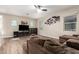 Comfortable living room with a plush sectional couch, large TV, and natural light at 8430 W Atlantis Way, Tolleson, AZ 85353