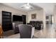 Comfortable living room featuring a leather couch, neutral walls, and tile floors at 8430 W Atlantis Way, Tolleson, AZ 85353