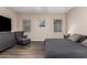 The main bedroom features wood-look flooring, a fan, and large windows for a naturally well-lit space at 8430 W Atlantis Way, Tolleson, AZ 85353