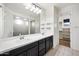 Bathroom features double sinks, large mirror, and walk-in shower adjacent to walk-in closet at 10024 E Tamery Ave, Mesa, AZ 85212