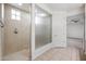 Walk-in shower features glass enclosure and tile surround in this well-lit bathroom at 10024 E Tamery Ave, Mesa, AZ 85212