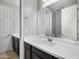 Modern bathroom with double vanity featuring sleek countertops, dark cabinets, and a large mirror at 10024 E Tamery Ave, Mesa, AZ 85212