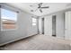 Bedroom with neutral carpet, ceiling fan, and a closet with sliding doors at 10024 E Tamery Ave, Mesa, AZ 85212