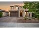 Charming two-story home with a well-manicured front yard and a two-car garage at 10024 E Tamery Ave, Mesa, AZ 85212