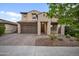 Charming two-story home boasts a well-manicured yard, a spacious garage, and lovely desert landscaping at 10024 E Tamery Ave, Mesa, AZ 85212