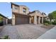 Attractive home with a brick-paved driveway, a two-car garage, and a beautifully landscaped front yard at 10024 E Tamery Ave, Mesa, AZ 85212