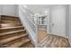 Elegant foyer featuring a staircase, built-in bookshelves, and stylish tile flooring at 10024 E Tamery Ave, Mesa, AZ 85212