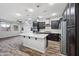 Spacious kitchen island with granite countertops, stainless steel appliances, and a view of the living room at 10024 E Tamery Ave, Mesa, AZ 85212