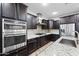 Modern kitchen featuring stainless steel appliances, dark cabinets, and granite countertops at 10024 E Tamery Ave, Mesa, AZ 85212