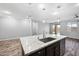 Modern kitchen island with granite countertops, stainless steel sink, and designer pendant lighting at 10024 E Tamery Ave, Mesa, AZ 85212