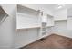 Walk-in closet with built-in shelving and hanging rods for ample storage space at 10024 E Tamery Ave, Mesa, AZ 85212