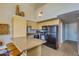 Efficient kitchen featuring black appliances, light cabinetry, and breakfast bar seating at 1005 E 8Th St # 3017, Tempe, AZ 85281