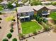 Aerial view of backyard with lush green lawn, mature landscaping, patio and balcony at 110 W Yellow Bee Dr, San Tan Valley, AZ 85143