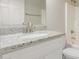 Bright bathroom with a granite countertop, modern fixtures, and neutral white cabinets at 110 W Yellow Bee Dr, San Tan Valley, AZ 85143