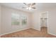 Bright, carpeted bedroom featuring a ceiling fan, two windows and a closet at 110 W Yellow Bee Dr, San Tan Valley, AZ 85143