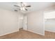 Bedroom showcasing a ceiling fan and carpeting, with access to closet and other rooms at 110 W Yellow Bee Dr, San Tan Valley, AZ 85143