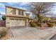 Home featuring a two-car garage, front yard with desert landscaping and blue front door at 110 W Yellow Bee Dr, San Tan Valley, AZ 85143