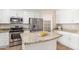 Well-lit kitchen with stainless steel appliances, granite counters, pantry, and white cabinets at 110 W Yellow Bee Dr, San Tan Valley, AZ 85143