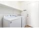 Functional laundry area with modern washer and dryer, complemented by practical shelving at 110 W Yellow Bee Dr, San Tan Valley, AZ 85143