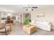 Inviting living room with tile floors, ceiling fan, and comfortable seating flowing into eat-in kitchen at 110 W Yellow Bee Dr, San Tan Valley, AZ 85143