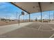 Outdoor covered basketball court with visible power lines in the background and a bench nearby at 11040 W Hayward Ave, Glendale, AZ 85307