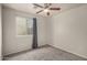 Cozy bedroom with plush carpeting, a ceiling fan, and a bright window with a drape at 11040 W Hayward Ave, Glendale, AZ 85307