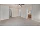 A neutral bedroom with a ceiling fan, carpeting, and entry into the bathroom at 11040 W Hayward Ave, Glendale, AZ 85307