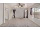 A main bedroom with neutral carpeting, ceiling fan, and windows with coverings at 11040 W Hayward Ave, Glendale, AZ 85307