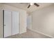 Bright bedroom featuring a ceiling fan and double door closet for ample storage at 11040 W Hayward Ave, Glendale, AZ 85307