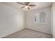 Carpeted bedroom with a window and a ceiling fan at 11040 W Hayward Ave, Glendale, AZ 85307