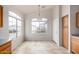 Bright dining area featuring tile flooring, large windows, and a contemporary light fixture at 11040 W Hayward Ave, Glendale, AZ 85307