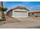 Home exterior with a two car garage and desert landscaping at 11040 W Hayward Ave, Glendale, AZ 85307