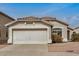 Charming single-story home with a two car garage, desert landscaping, and neutral stucco exterior at 11040 W Hayward Ave, Glendale, AZ 85307