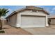 Home exterior with a two car garage and desert landscaping at 11040 W Hayward Ave, Glendale, AZ 85307