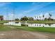 Scenic golf course view featuring a tranquil pond with a fountain, lush green grass, and palm trees at 11040 W Hayward Ave, Glendale, AZ 85307