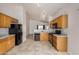 A kitchen featuring wooden cabinets, tile floor, and stainless steel appliances at 11040 W Hayward Ave, Glendale, AZ 85307