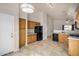 Spacious kitchen with wooden cabinets, black appliances, and tile flooring at 11040 W Hayward Ave, Glendale, AZ 85307