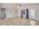 Spacious living room featuring neutral tile flooring, vaulted ceilings, and a ceiling fan at 11040 W Hayward Ave, Glendale, AZ 85307