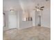 Bright living room featuring neutral tile flooring, an open floorplan, and white walls at 11040 W Hayward Ave, Glendale, AZ 85307