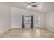 Spacious living room featuring neutral tile flooring, vaulted ceilings, and a ceiling fan at 11040 W Hayward Ave, Glendale, AZ 85307