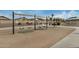 Community playground featuring swings, with soft landing and a nearby bathroom at 11040 W Hayward Ave, Glendale, AZ 85307