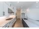 Modern kitchen featuring white cabinetry, stainless steel appliances, and a large island with a marble countertop at 11188 N Blakely St, Surprise, AZ 85388