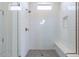 Modern shower featuring frameless glass, built-in niche and a comfortable bench at 11188 N Blakely St, Surprise, AZ 85388